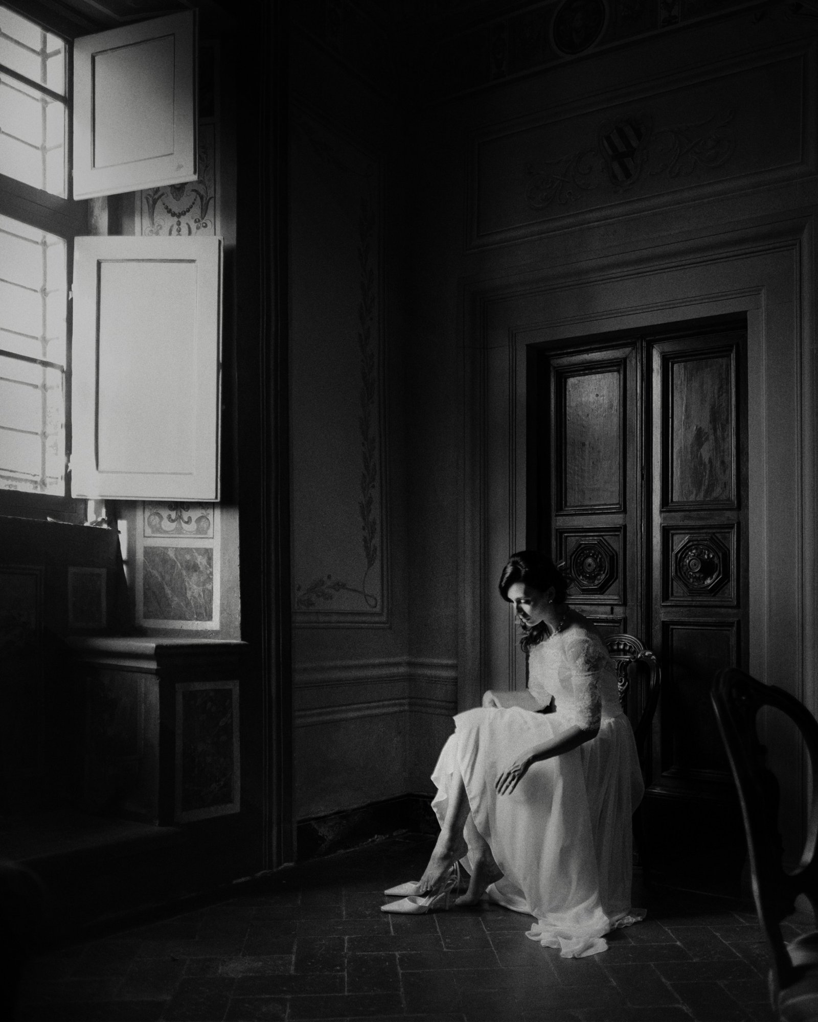 Bride seated beside window